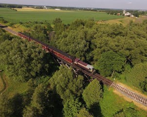 a large long train on a lush green field