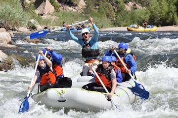 a group of people riding on a raft in the water