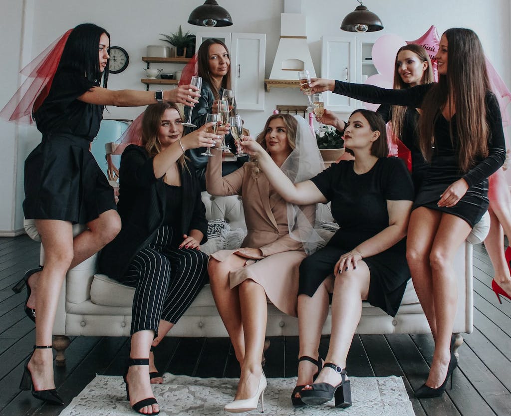 Young women raising glasses at bachelorette party