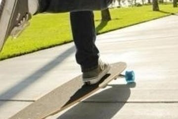 a person riding a skateboard up the side of a road