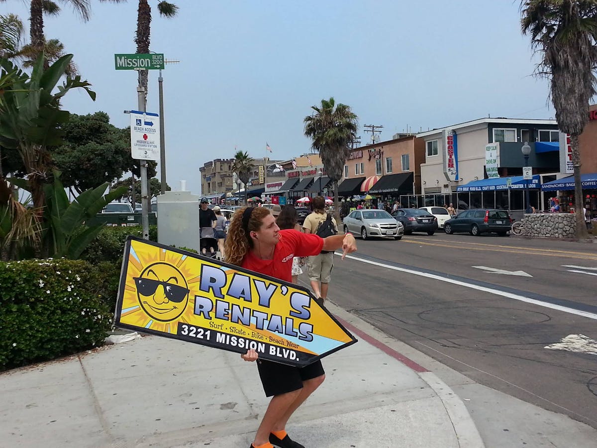 a person holding a sign in the middle of the street