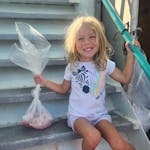 a little girl holding a kite