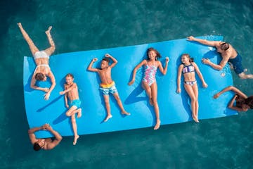 a group of people swimming in a pool of water