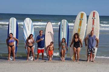 a group of people on a beach posing for the camera