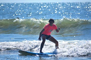 a person riding a wave on a surfboard in the ocean
