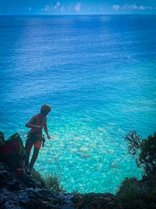 canyoning Madeira Island, a man on a waterfall looking at the ocean