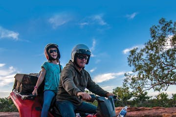 two people riding on the quad bike