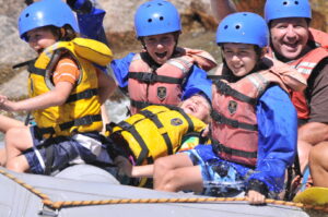 group of kids whitewater rafting
