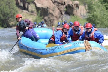 a group of people riding on a raft in a body of water