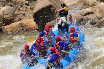 team working together on white water rafting retreat