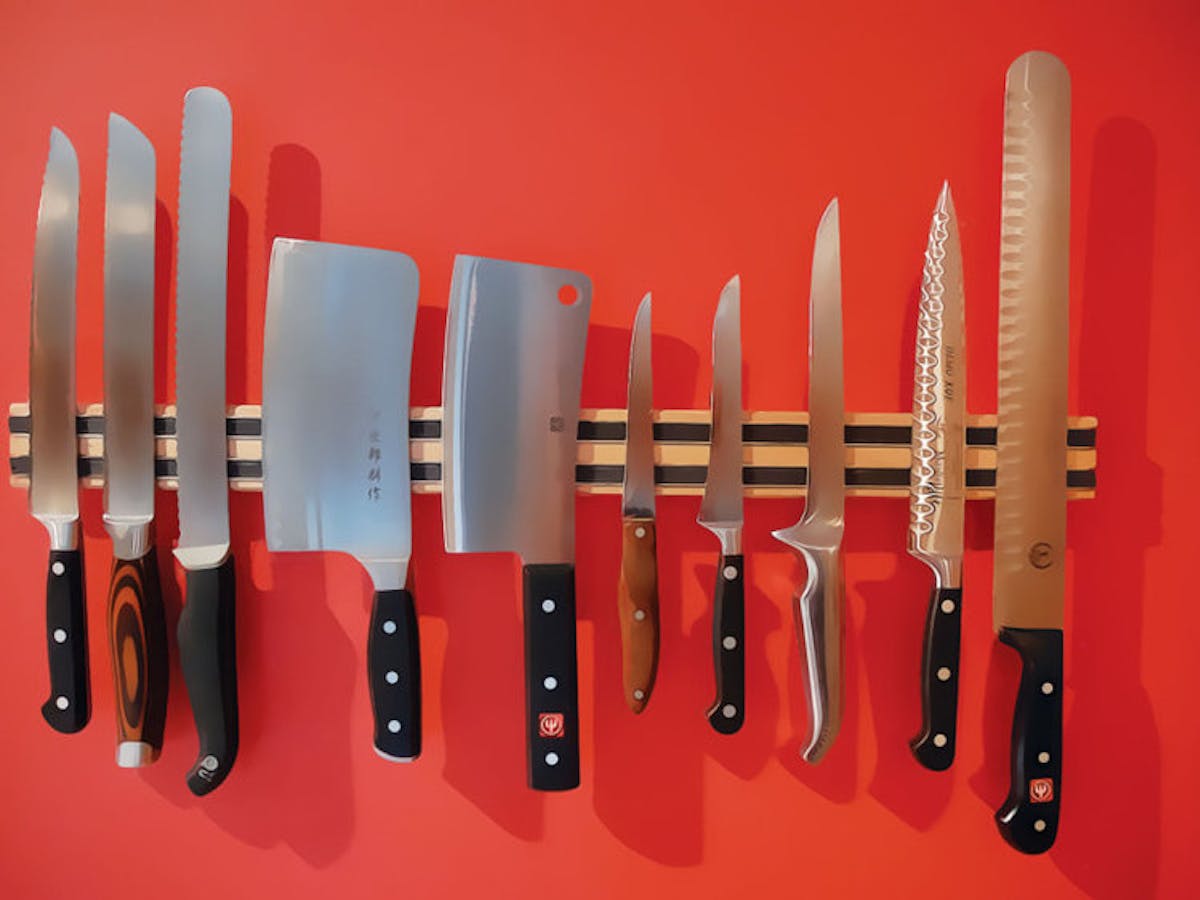 a row of Knifes on a table