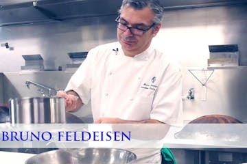 Bruno Feldeisen cooking in a kitchen preparing food