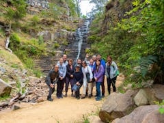 a group of people standing on a rocky path