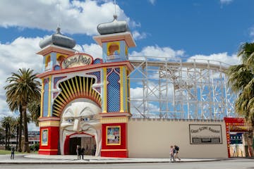 a group of people standing in front of Luna Park, Melbourne