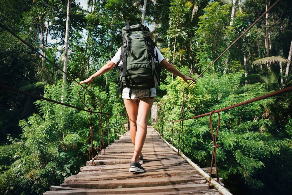 A woman walking on Hanging Bridges in Arenal