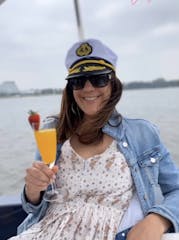 Blue Jacket relaxing in the boat with a glass of Mimosa
