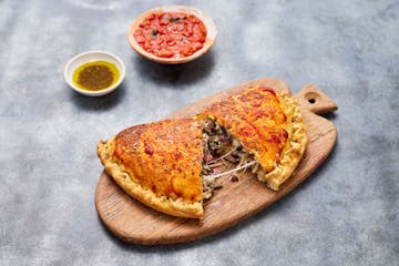 a slice of pizza sitting on top of a table