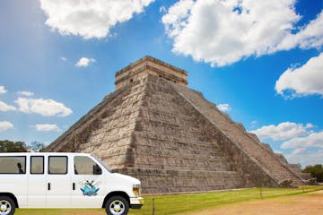 a bus parked in front of Chichen Itza