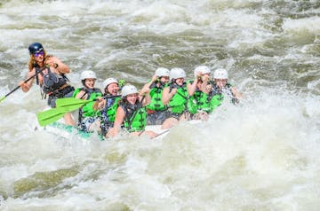 a group of people riding on top of a wave