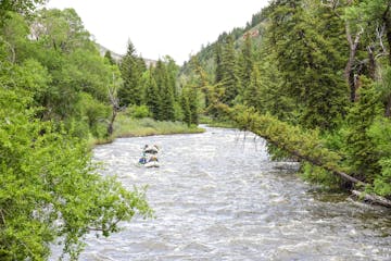 a person riding skis down a river next to a body of water