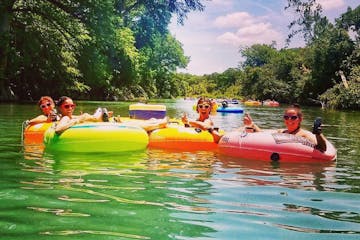 a group of people floating down a river