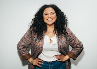 Michelle Buteau smiling for the camera