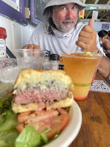 a man holding a sandwich in a restaurant