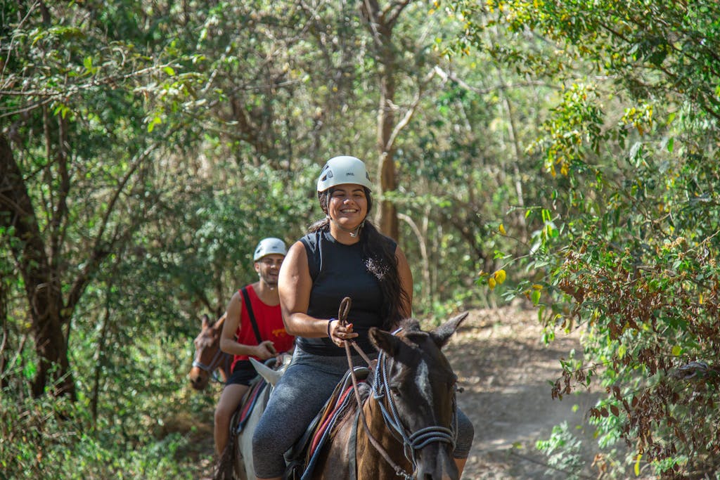 a person riding a horse in the forest