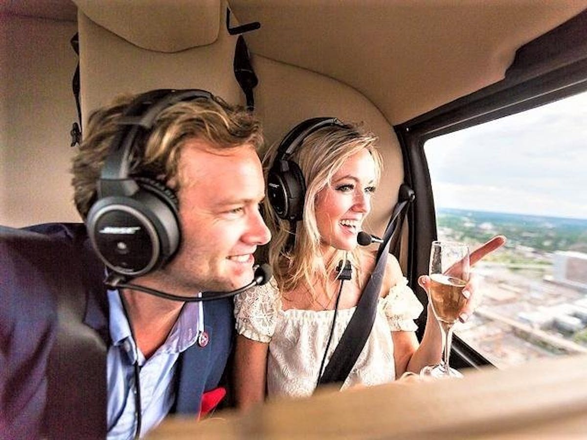 a couple enjoying the view from inside a helicopter