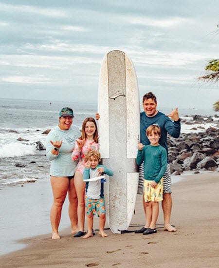 Family Enjoying Group Surfing Lessons