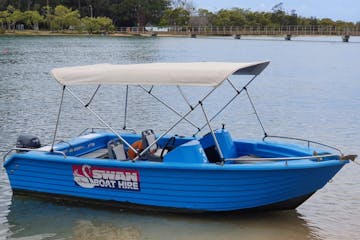 a small blue boat sitting next to a body of water