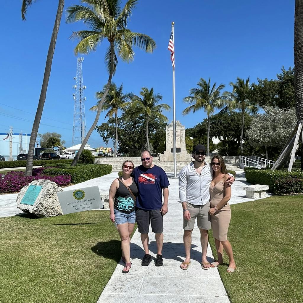 a group of people at the hurricane monument in islamorada florida