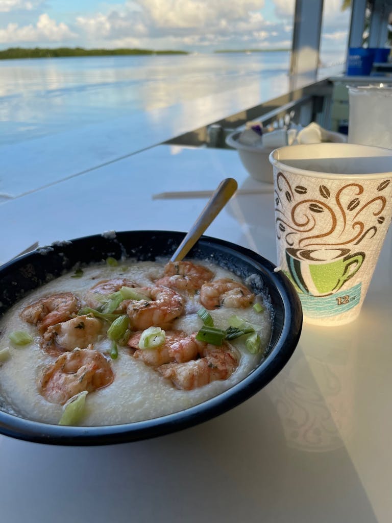 a plate of shrimp and grits and a cup of coffee at the Lorelei in Islamorada, Florida Keys
