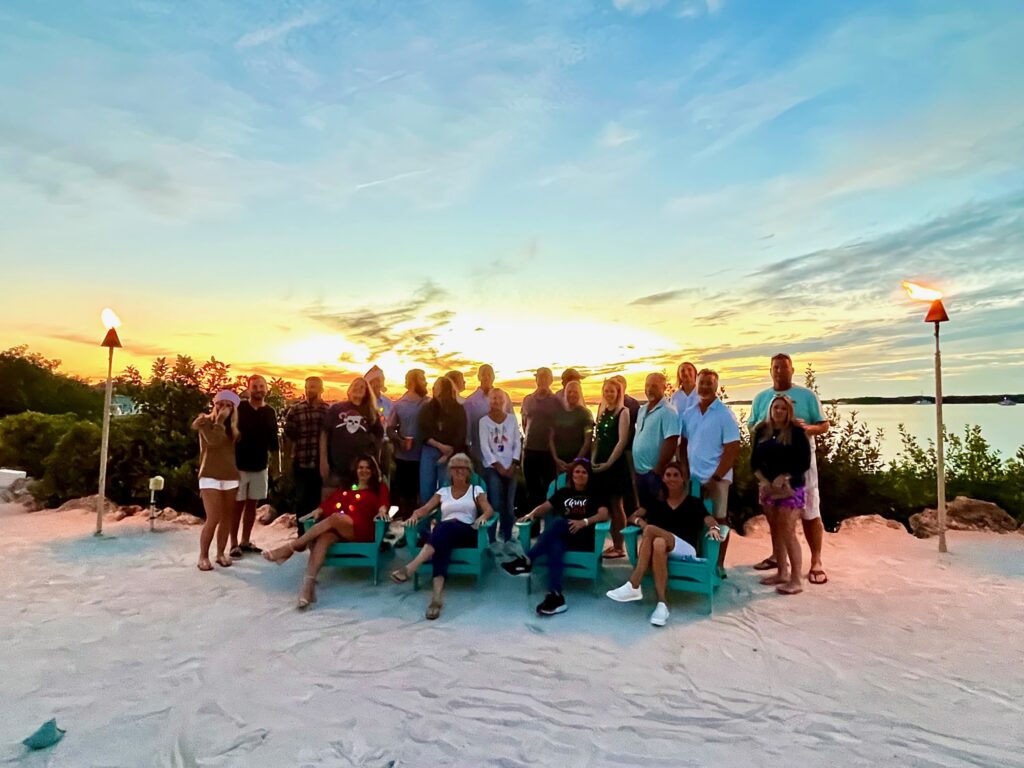a group of people on a  beach for a florida keys sunset 
