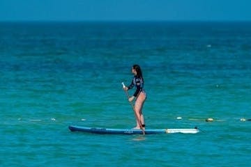 a girl riding a wave on a surfboard in the water