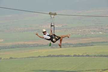 a man flying through the air on a swing