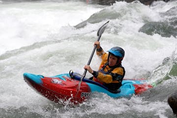 a man riding a wave on a raft in a body of water