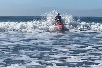a man riding a wave on a surfboard in the ocean