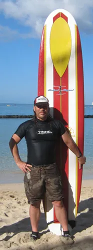 man in front of surfboard