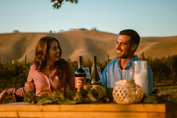 a couple enjoying their date night and picnic on the vineyard in Wine Country After Hours