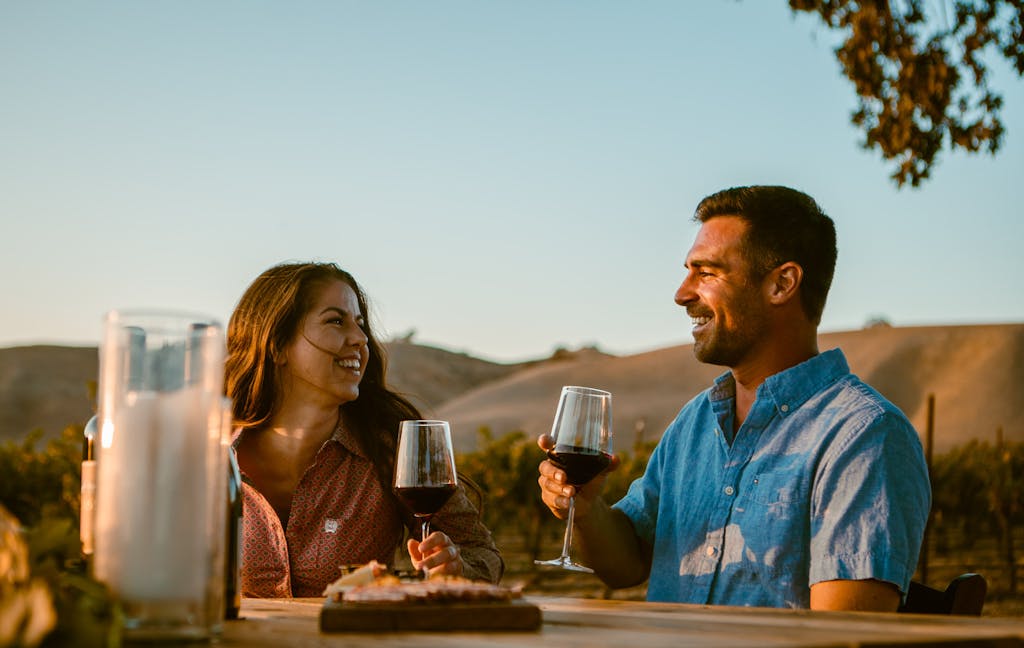 a couple enjoying wine during their private picnic in wine country