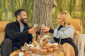 a couple enjoying a luxury picnic on the vineyard