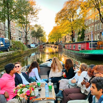 a group of young people on an Amsterdam open boat tour through Jordaan