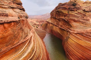 a view of a canyon with Vermilion Cliffs National Monument in the background