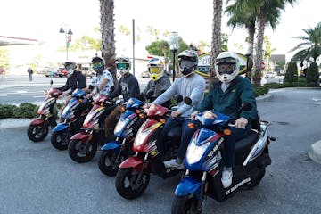 a group of people on scooters