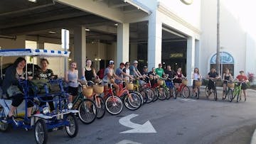 a group of people posing with bicycles