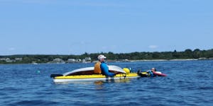 Sea kayakers practicing boat over boat T rescues
