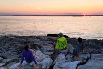 Watching the sunset over the rocky coast of the Penobscot Acadia Downeast region