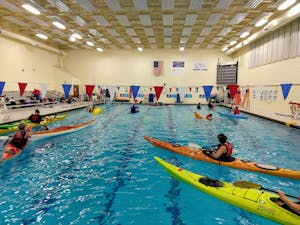 Sea kayaks and open recreation kayaks practice in the pool 