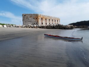 A Kayak on the beach with Fort Popham in the background